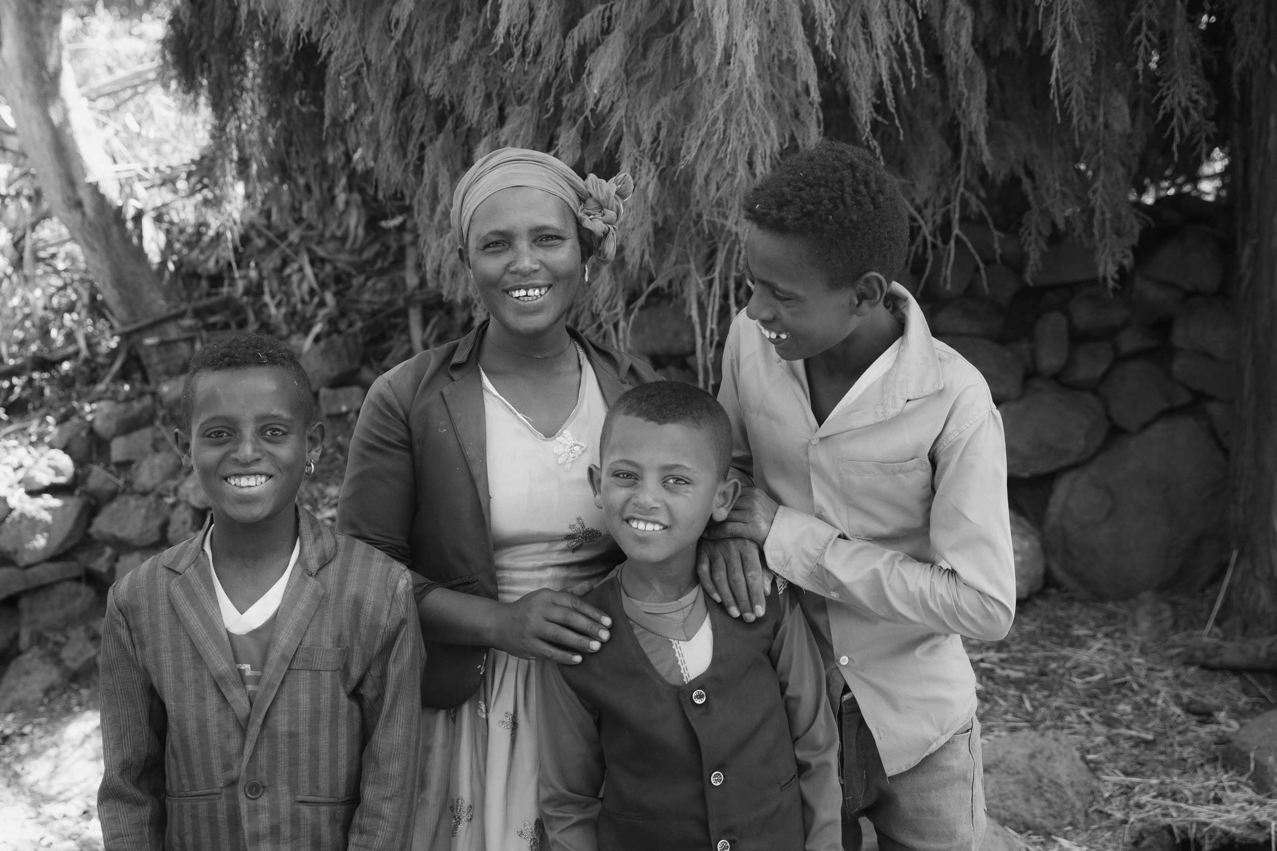 Effaa and her three sons pose for a photo in their backyard